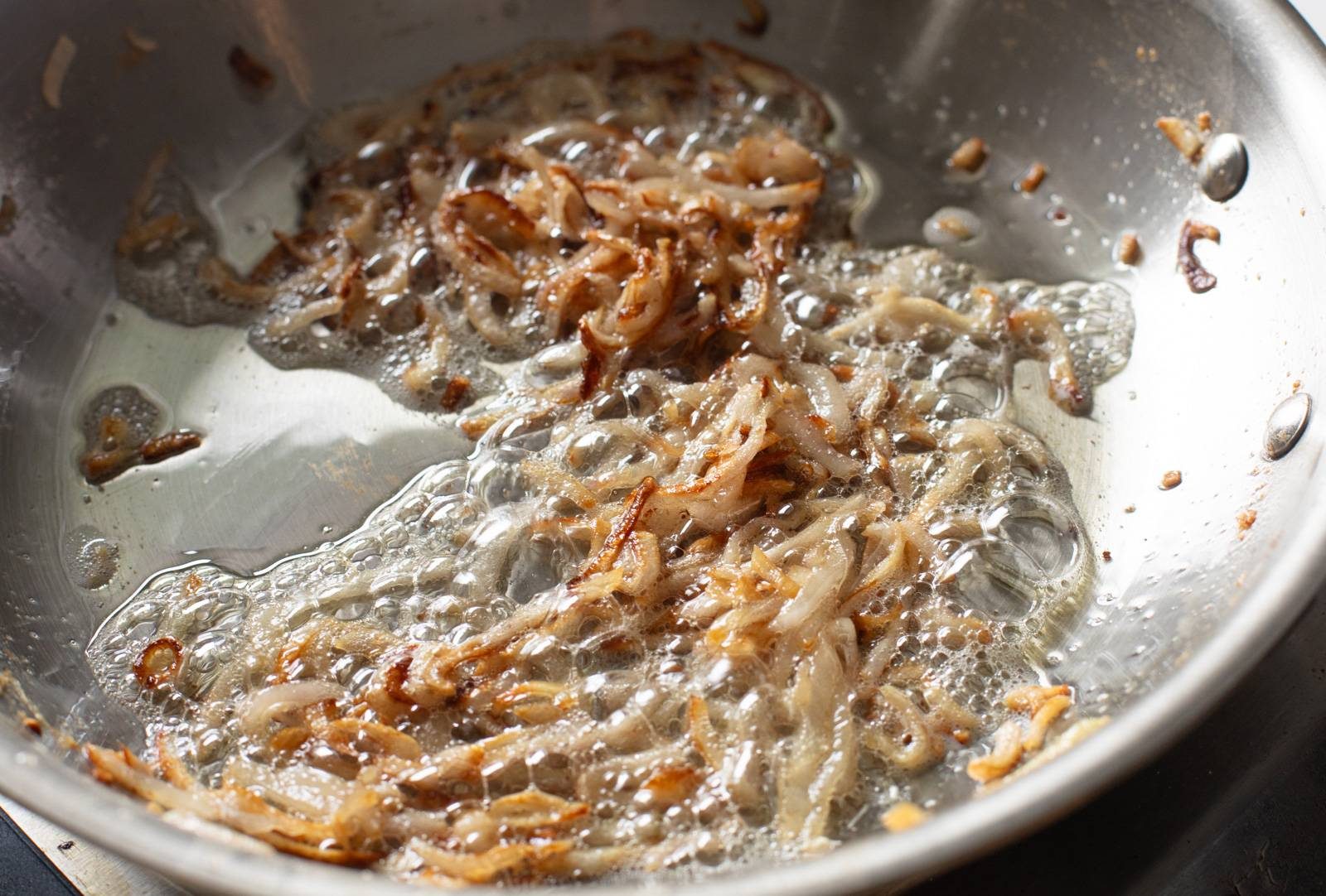 Sliced shallots in a pan.