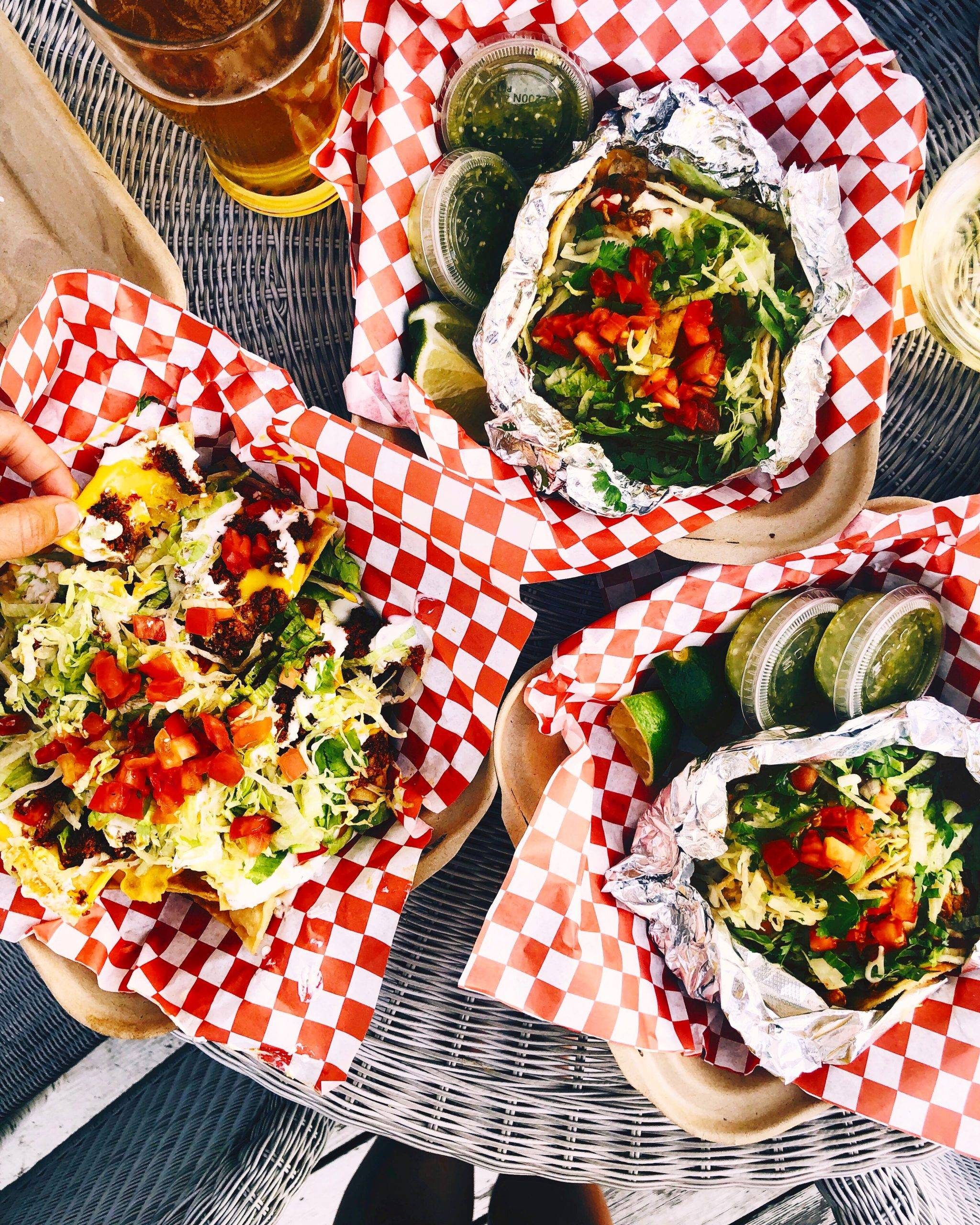 A table full of tacos and sauce and other mexican food!