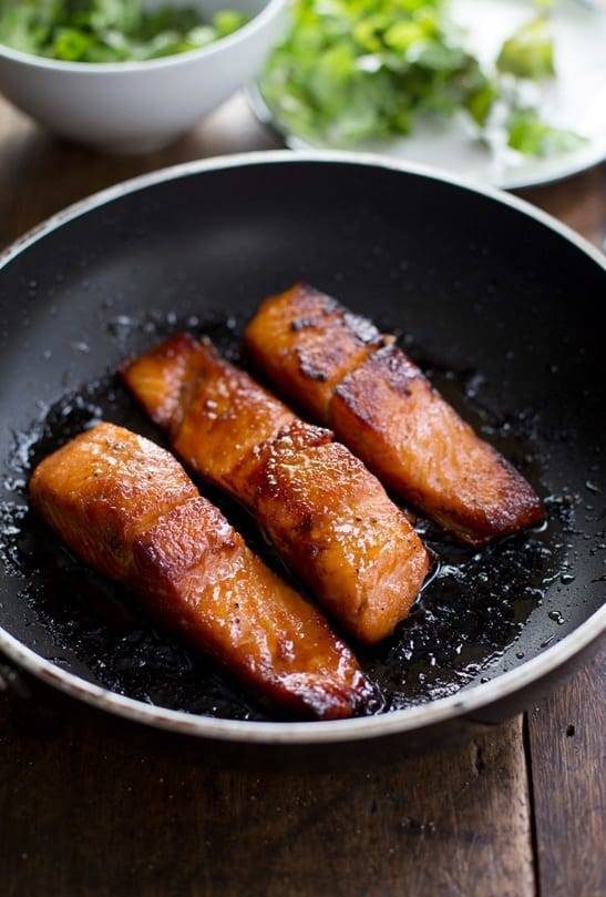 Caramelized salmon in a pan.