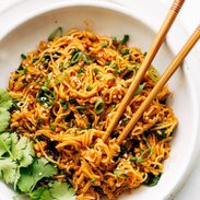 Bowl of gochujang noodles with chopsticks.