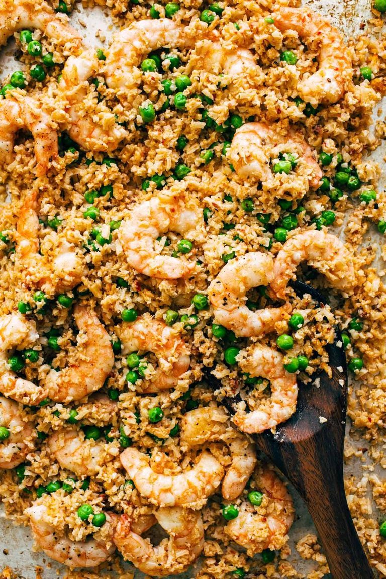Sheet pan with shrimp, cauliflower rice, and peas.