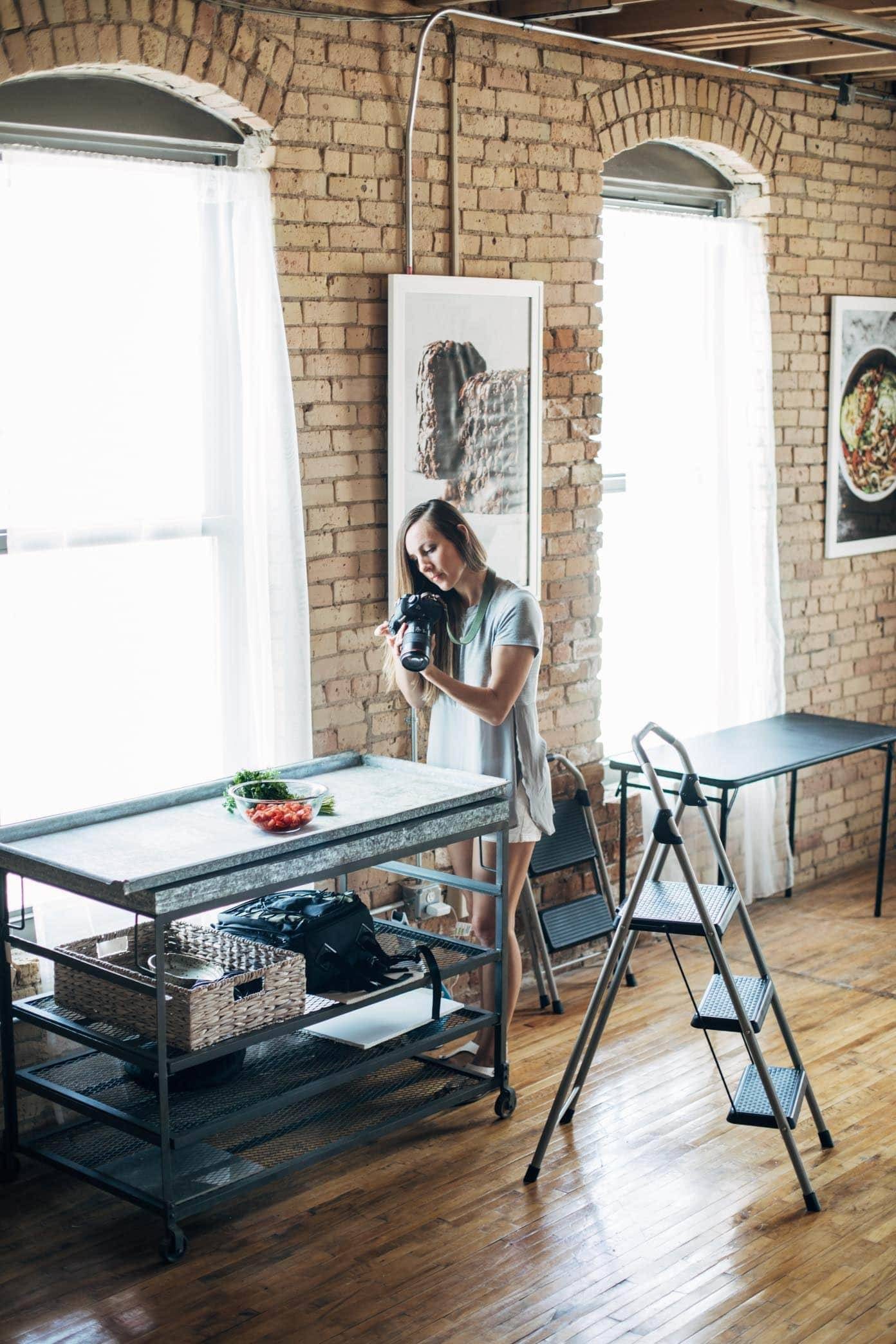 Woman taking photos in an office space.