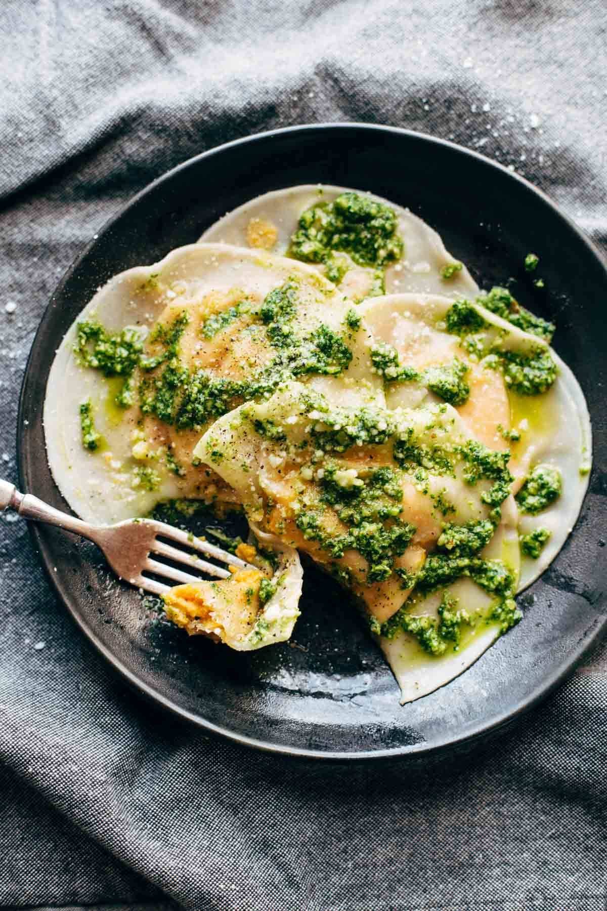 Butternut Squash Ravioli on a plate with a fork.