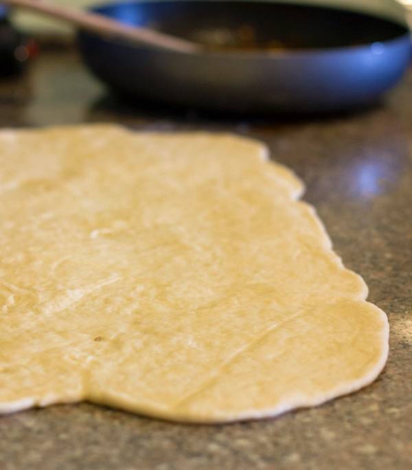 Dough rolled out on a countertop.