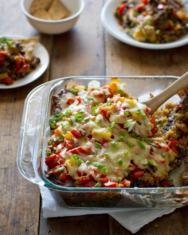 Quinoa and black bean casserole in a clear baking dish.