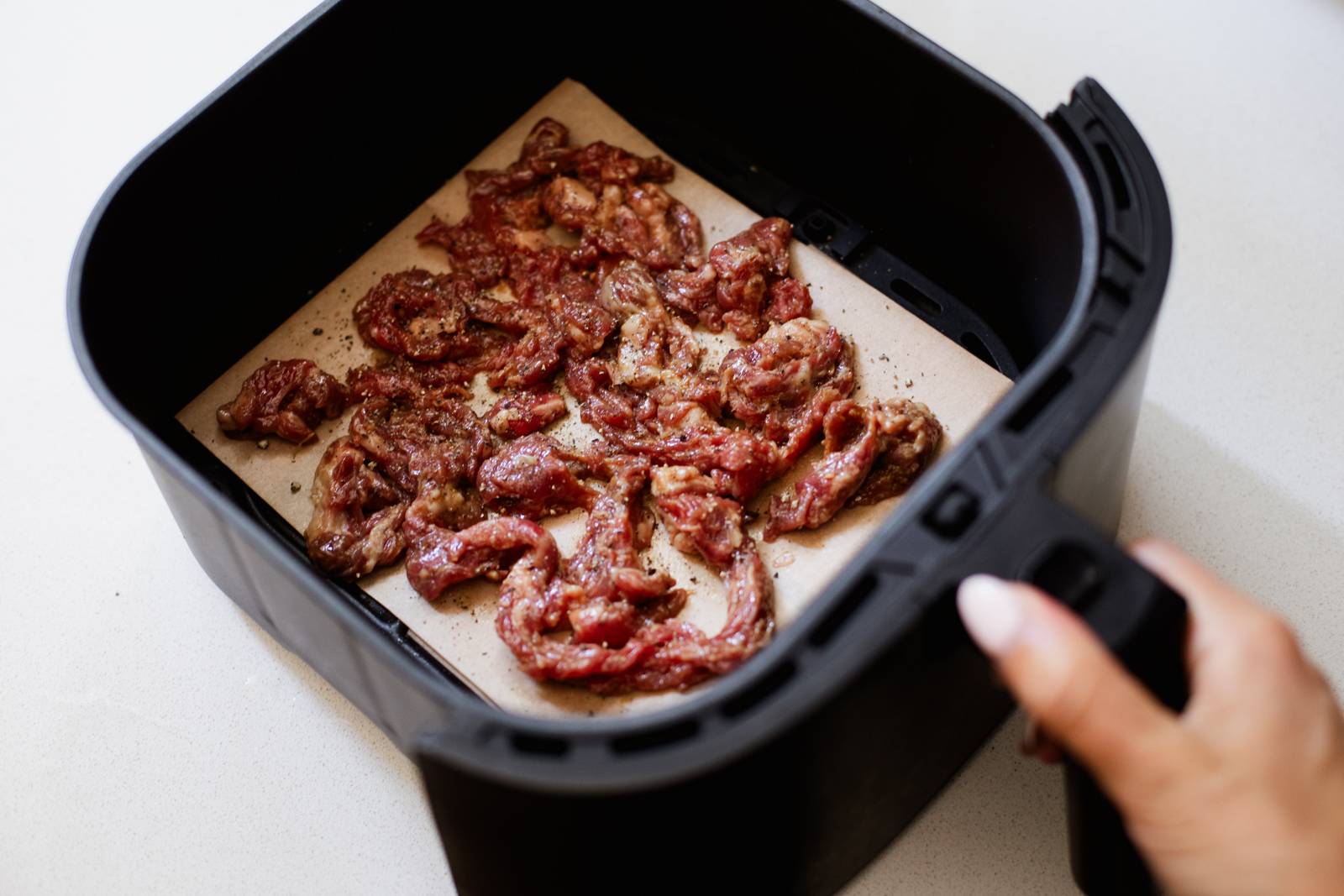 Steak strips in an air fryer.