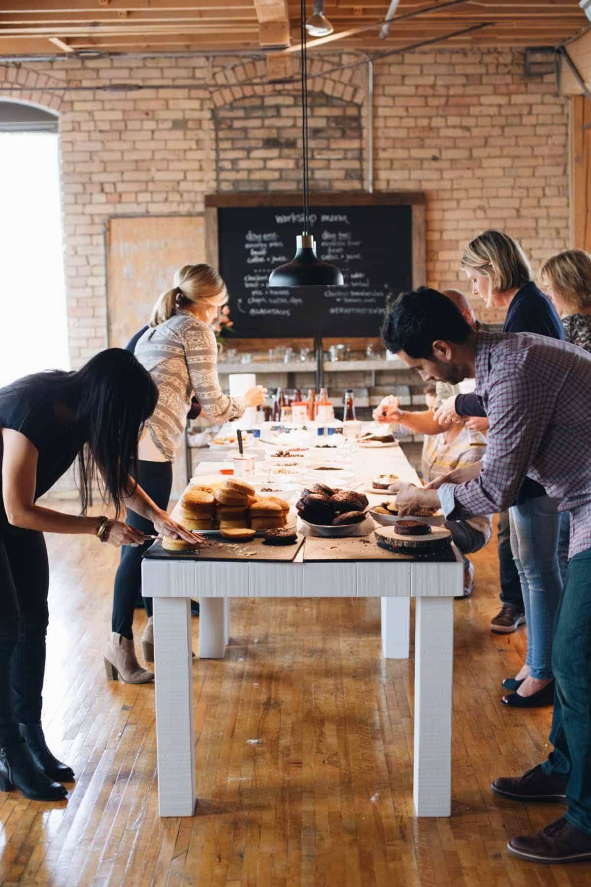 People around a table styling food.