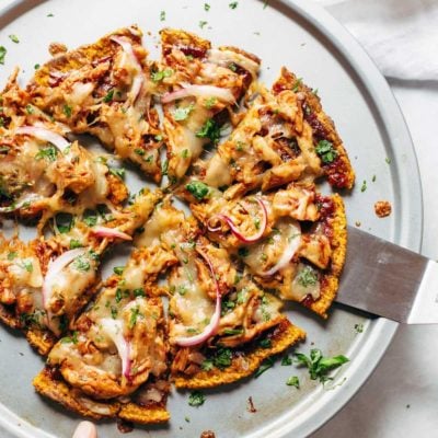 Sweet Potato Pizza on pizza pan with spatula.