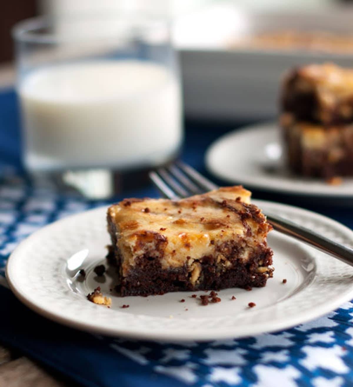 One white chocolate cheesecake brownie on a plate.