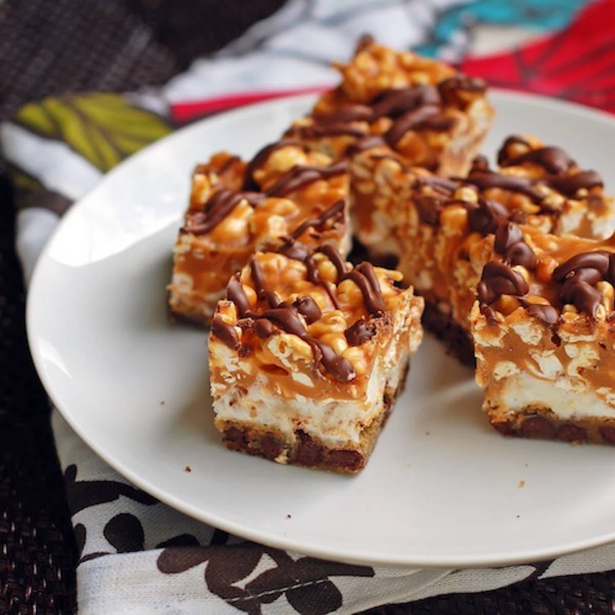 Caramel corn bars with a marshmallow caramel corn topping, drizzled with chocolate.