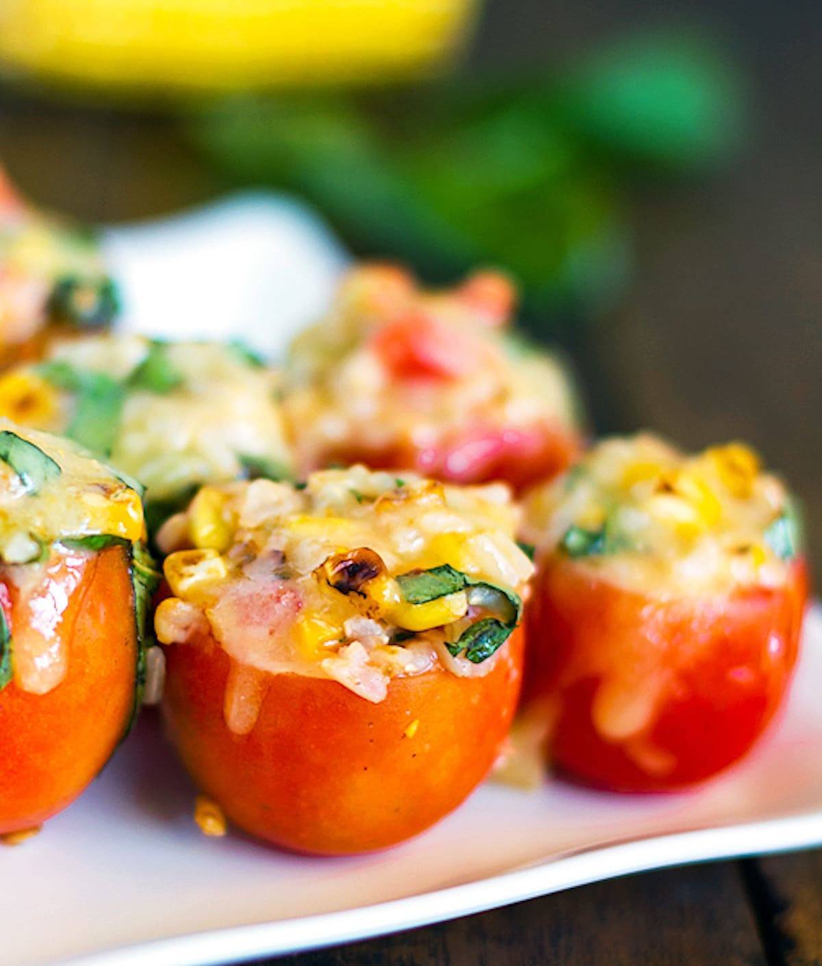 Stuffed tomatoes filled to the brim with roasted corn, fresh basil, and topped with melted Mozzarella cheese.