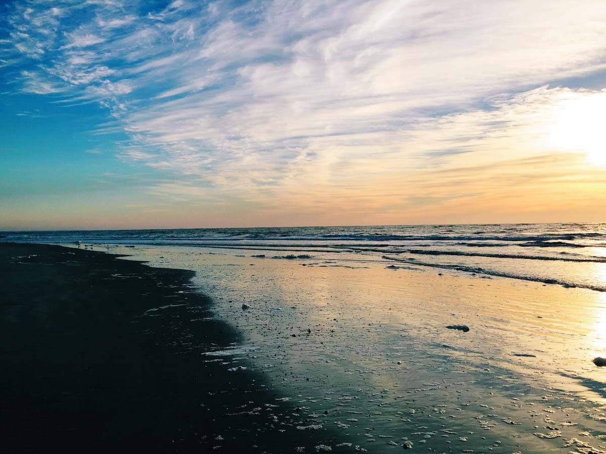 Ocean shore during sunset.